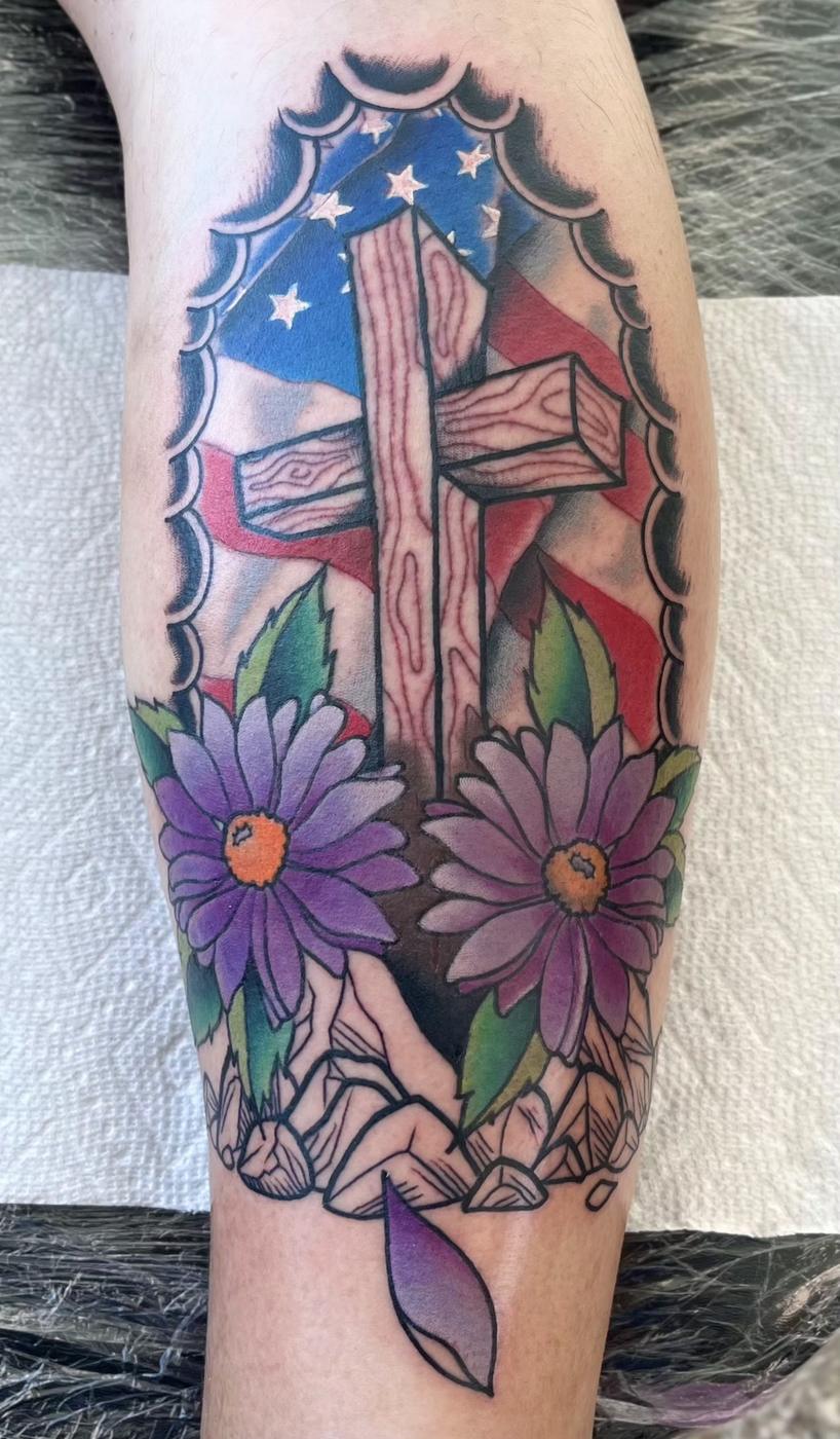 Colour cross with a flag and purple daisies on a calf.