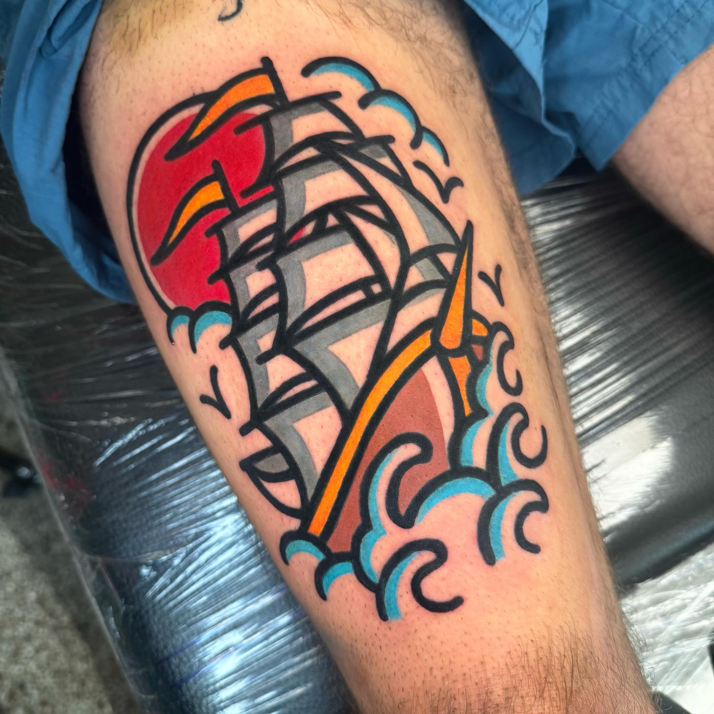 American traditional clipper ship in bold colour on a lower leg.